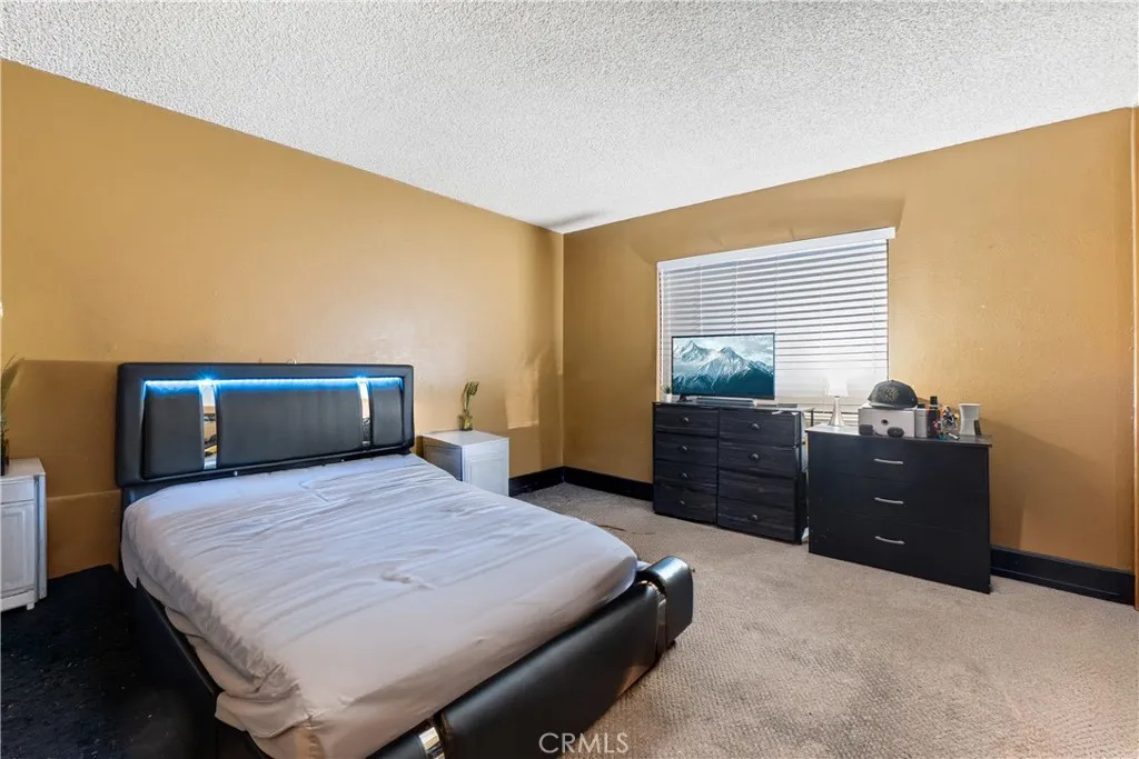 1051 Site, Unit 251 Brea, CA 92821 - Photo 15 of 23 a bedroom with a bed and wooden floor