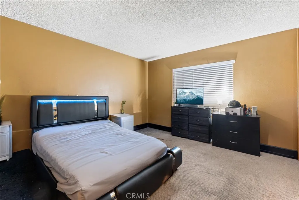 1051 Site, Unit 251 Brea, CA 92821 - Photo 15 of 23 a bedroom with a bed and wooden floor