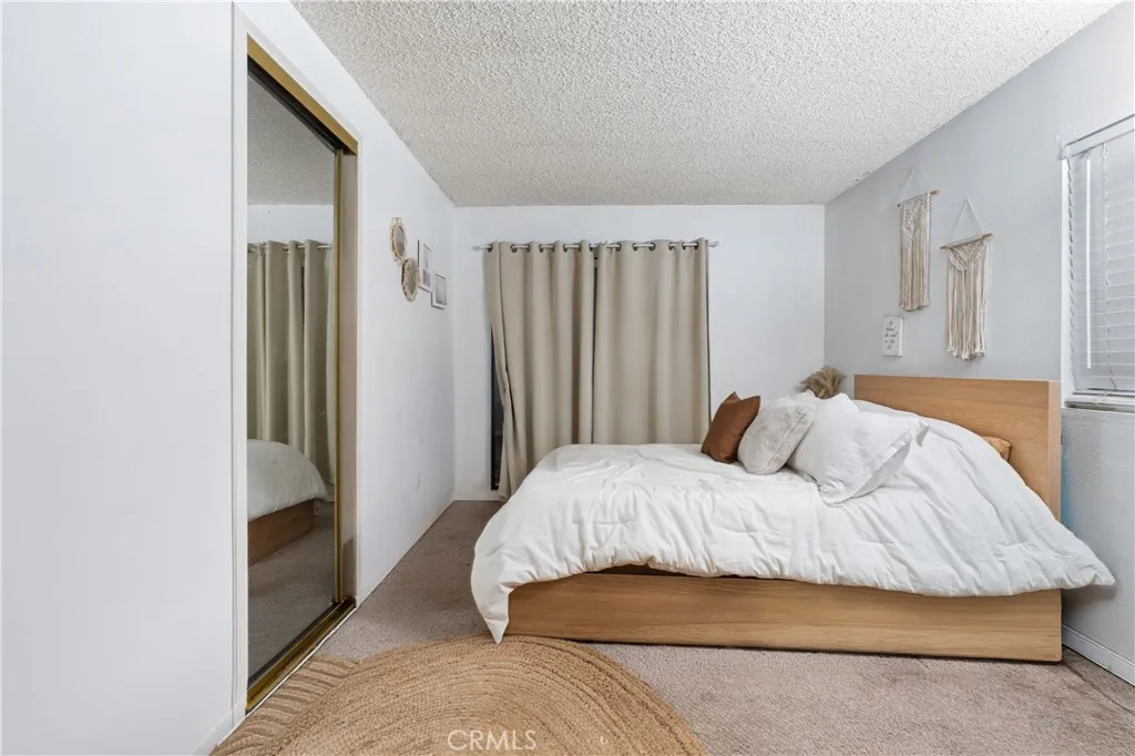 1051 Site, Unit 251 Brea, CA 92821 - Photo 16 of 23 a bedroom with a bed and a walk in closet
