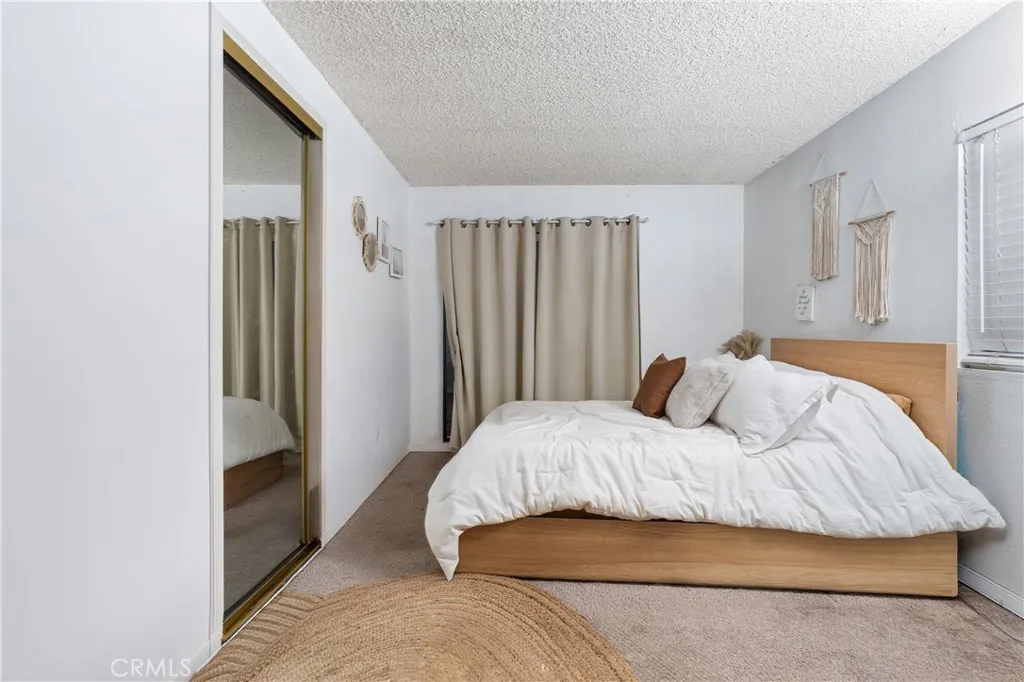 1051 Site, Unit 251 Brea, CA 92821 - Photo 16 of 23 a bedroom with a bed and a walk in closet