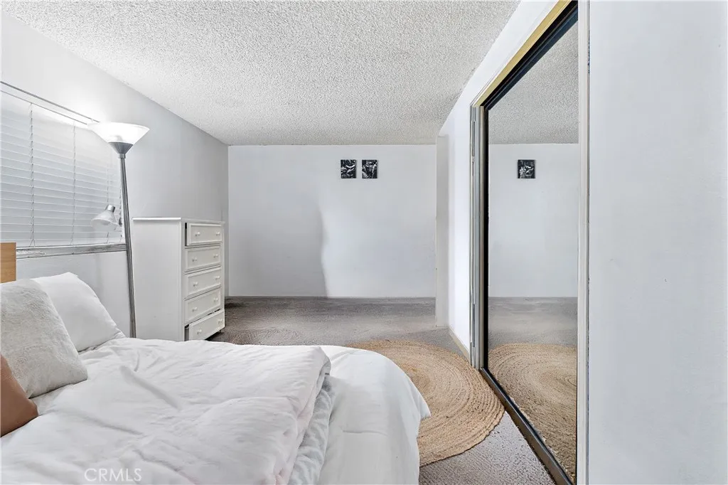 1051 Site, Unit 251 Brea, CA 92821 - Photo 17 of 23 a bedroom with a bed and a mirror