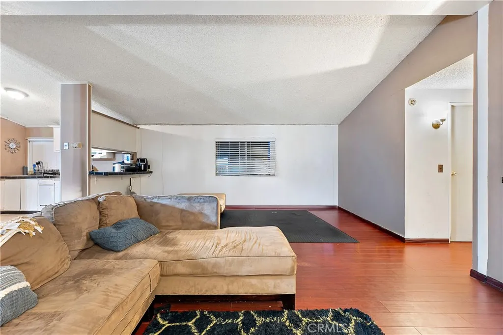 1051 Site, Unit 251 Brea, CA 92821 - Photo 7 of 23 a bedroom with a bed and wooden floor