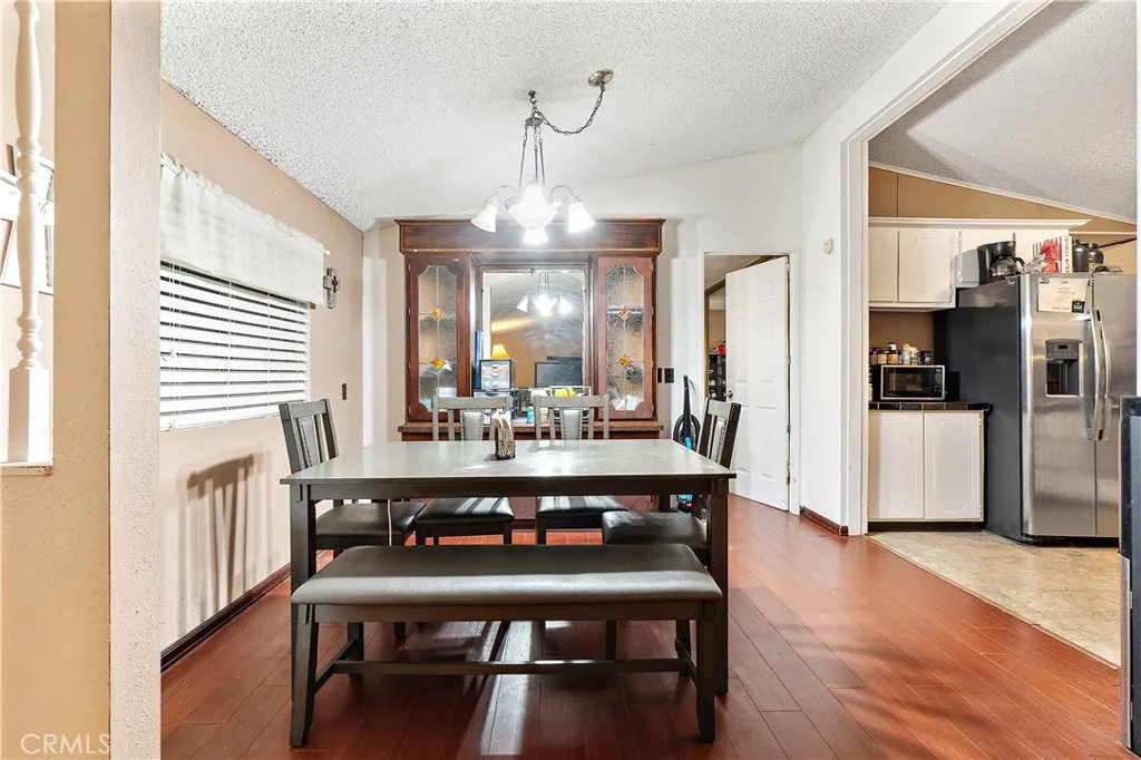 1051 Site, Unit 251 Brea, CA 92821 - Photo 9 of 23 a view of a dining room with furniture and wooden floor