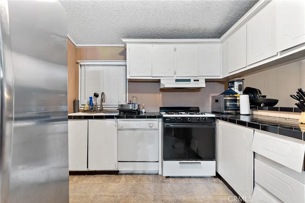 1051 Site, Unit 251 Brea, CA 92821 - Photo 10 of 23 a kitchen with cabinets and white stainless steel appliances