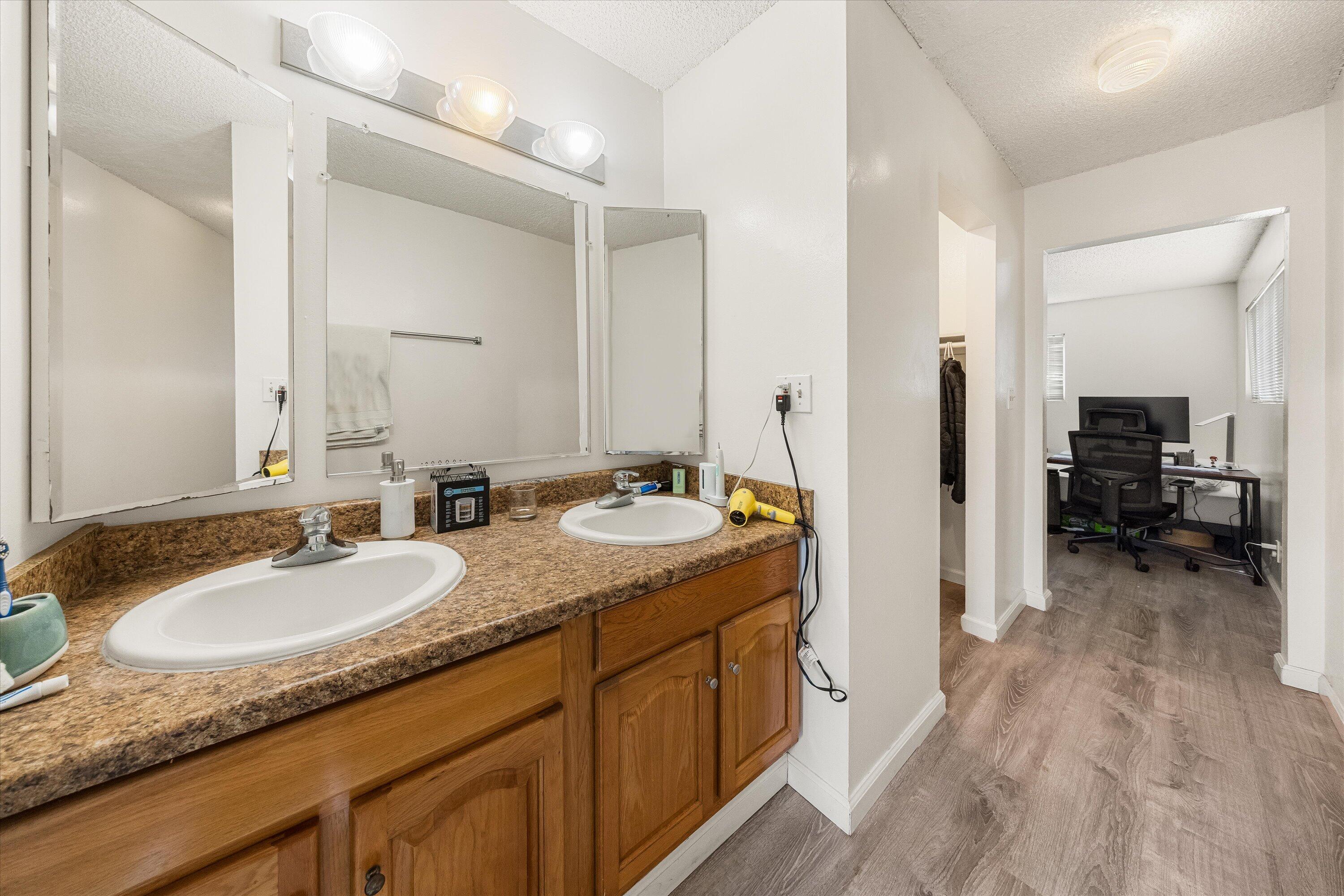 6724 Pasado Road Goleta, CA 93117 - Photo 12 of 24 a en suite bathroom with sinks granite countertop tub and a mirror