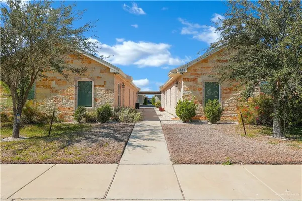 a pathway of a house with a yard