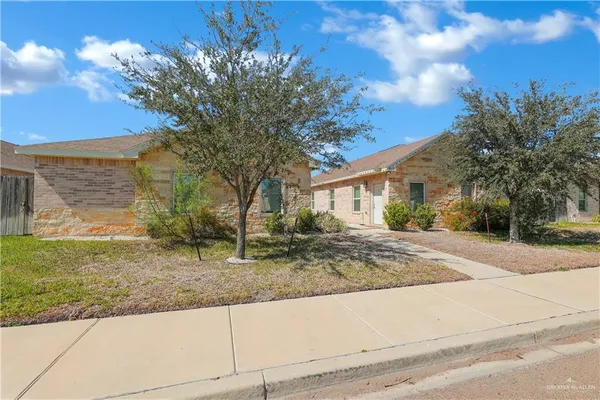 a view of a house with a tree in the background