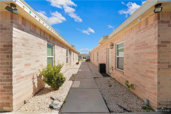 a view of a pathway with a potted plants