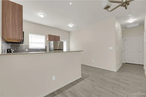 a kitchen with granite countertop a refrigerator and a sink