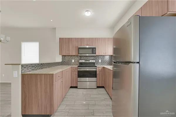 a kitchen with a stove top oven and cabinets