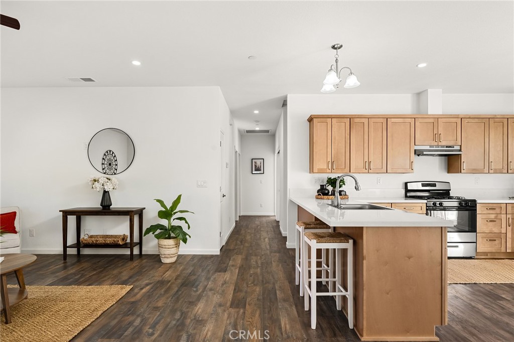 6078 Maxwell Drive Paradise, CA 95969 - Photo 13 of 44 a open kitchen with stainless steel appliances granite countertop a stove refrigerator and a dining table with wooden floor