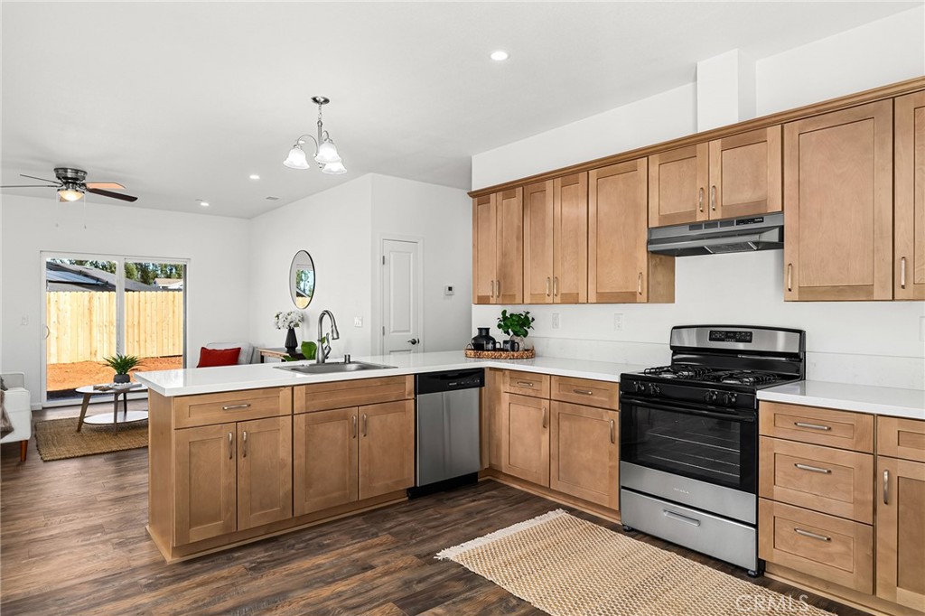 6078 Maxwell Drive Paradise, CA 95969 - Photo 15 of 44 a kitchen with white cabinets stainless steel appliances and wooden floor