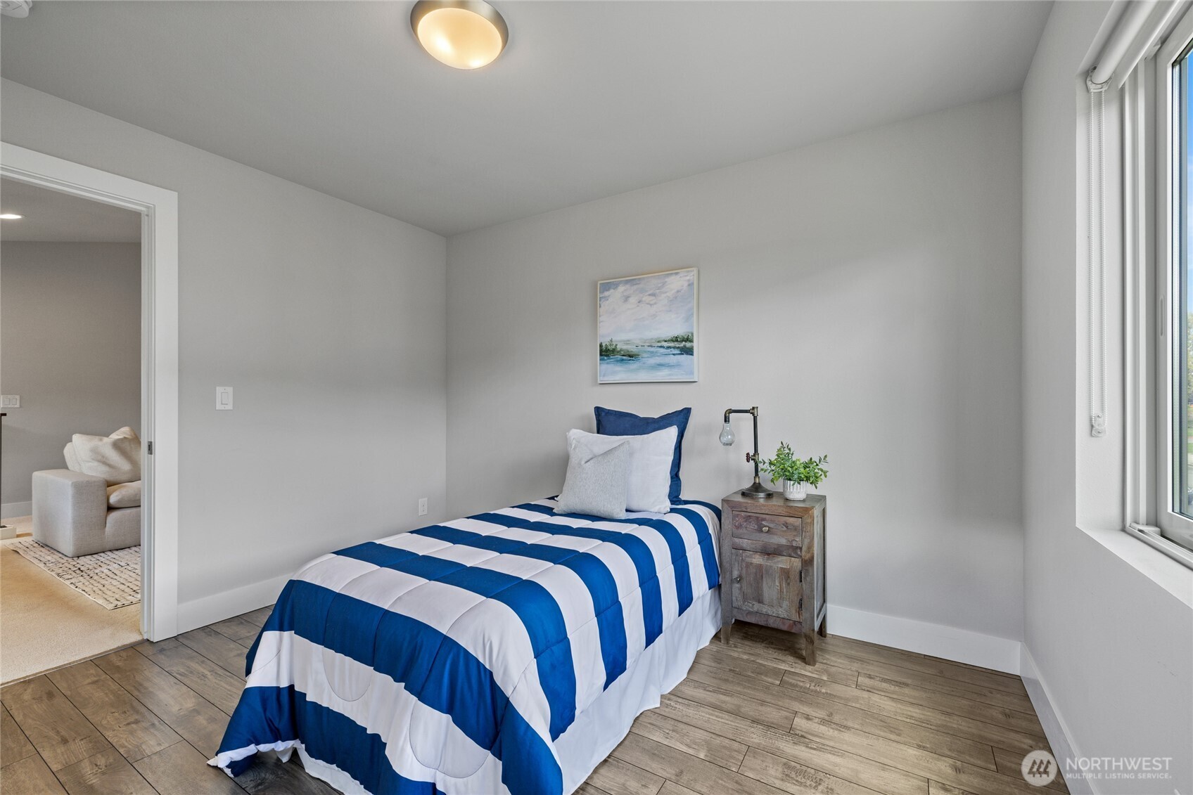 24903 123rd Place Southeast Kent, WA 98030 - Photo 30 of 40 a bedroom with a bed and wooden floor