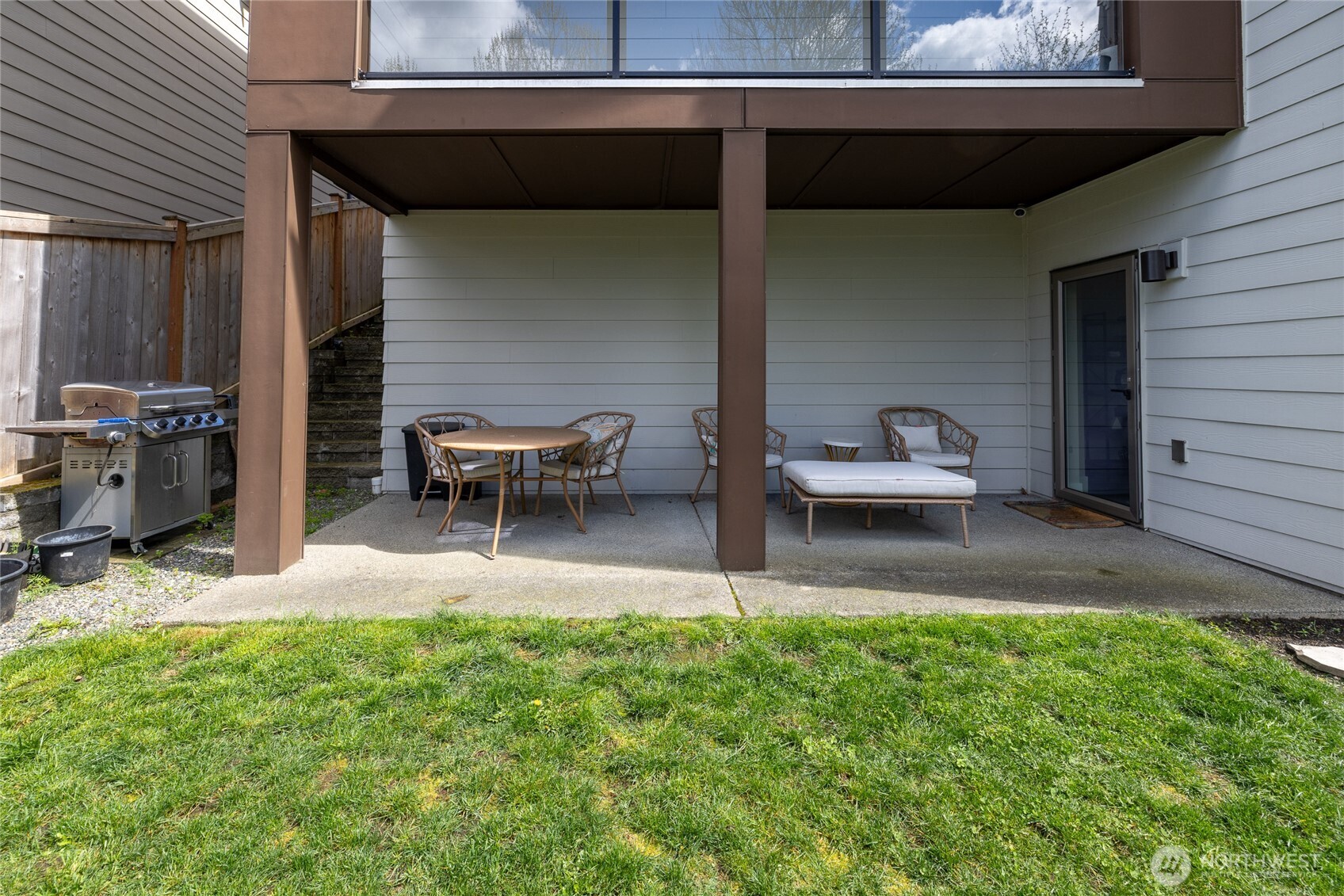 24903 123rd Place Southeast Kent, WA 98030 - Photo 38 of 40 a view of a backyard with table and chairs potted plants and a wooden deck