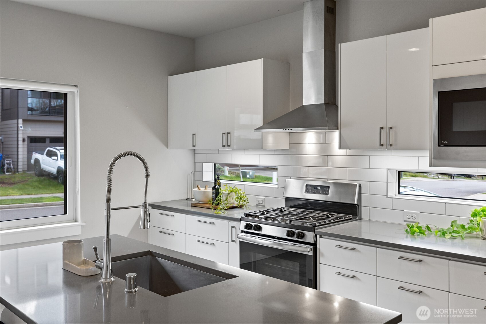 24903 123rd Place Southeast Kent, WA 98030 - Photo 4 of 40 a kitchen with stainless steel appliances granite countertop a sink stove and refrigerator