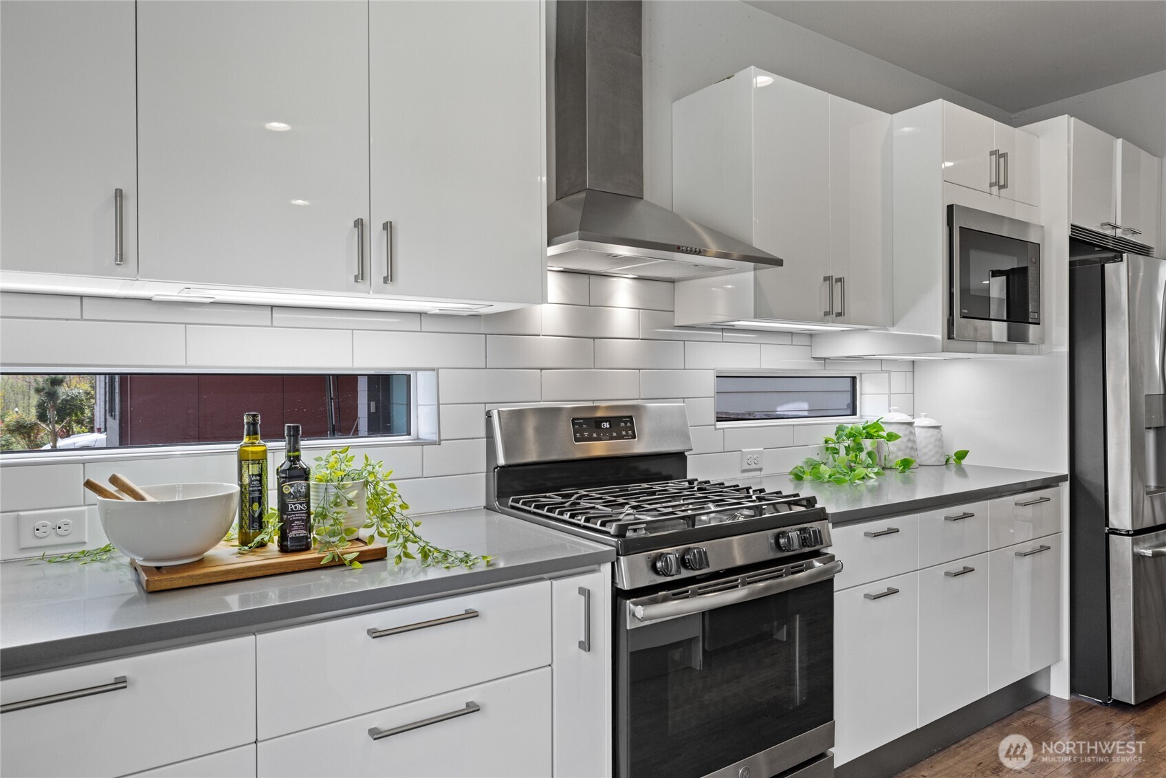 24903 123rd Place Southeast Kent, WA 98030 - Photo 6 of 40 a kitchen with stainless steel appliances kitchen island granite countertop a stove a sink and white cabinets