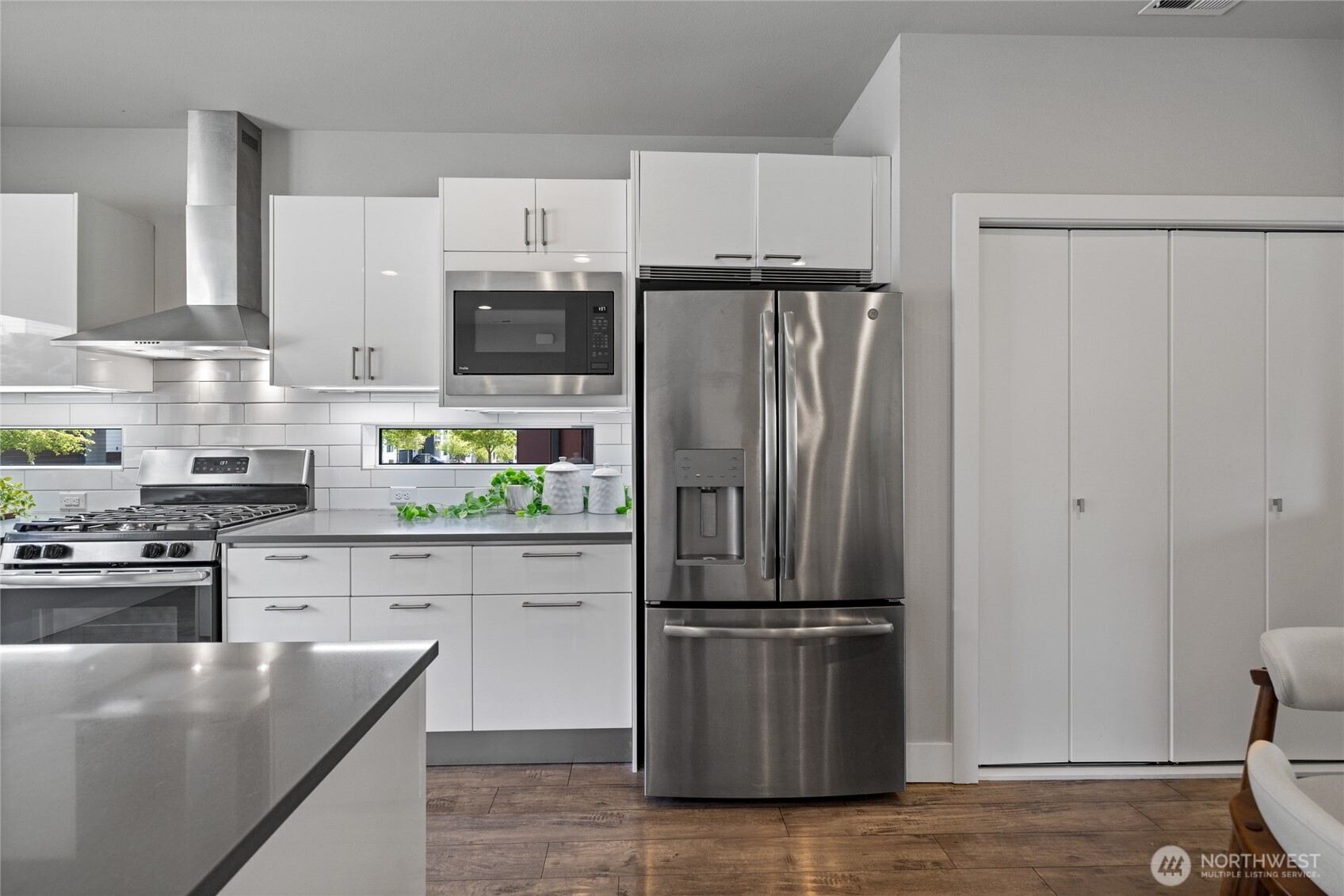 24903 123rd Place Southeast Kent, WA 98030 - Photo 7 of 40 a kitchen with granite countertop a refrigerator and a stove top oven
