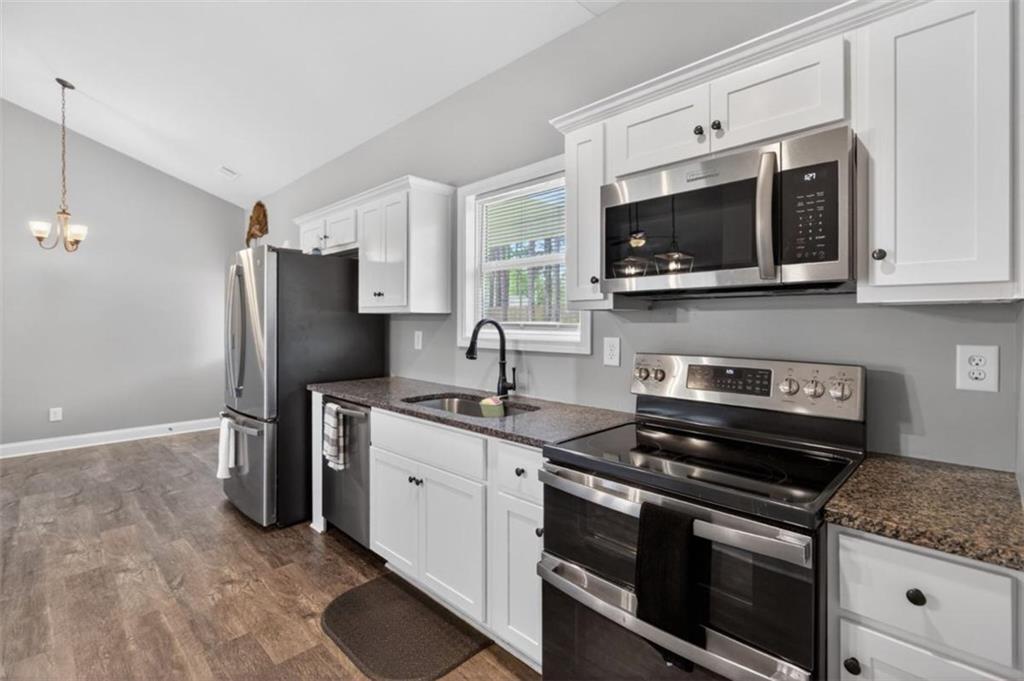 184 King Farm Road Rockmart, GA 30153 - Photo 12 of 25 a kitchen with stainless steel appliances granite countertop a stove microwave and refrigerator