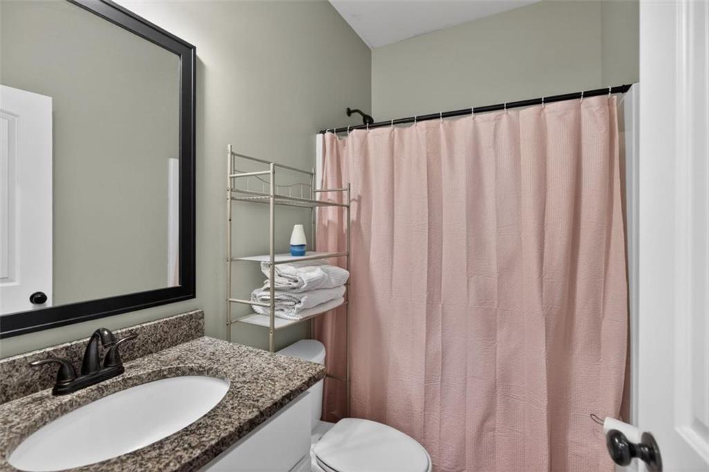 184 King Farm Road Rockmart, GA 30153 - Photo 15 of 25 a bathroom with a granite countertop sink and a mirror