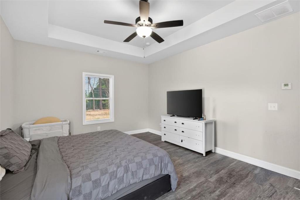 184 King Farm Road Rockmart, GA 30153 - Photo 18 of 25 a bedroom with a bed and a flat screen tv