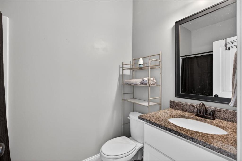 184 King Farm Road Rockmart, GA 30153 - Photo 19 of 25 a bathroom with a granite countertop toilet sink and mirror