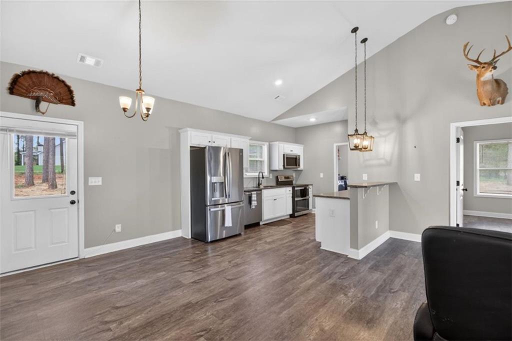 184 King Farm Road Rockmart, GA 30153 - Photo 9 of 25 a view of a kitchen with furniture and wooden floor