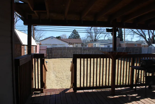 a view of a balcony with chairs and wooden floor