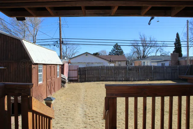 a view of a house with wooden fence