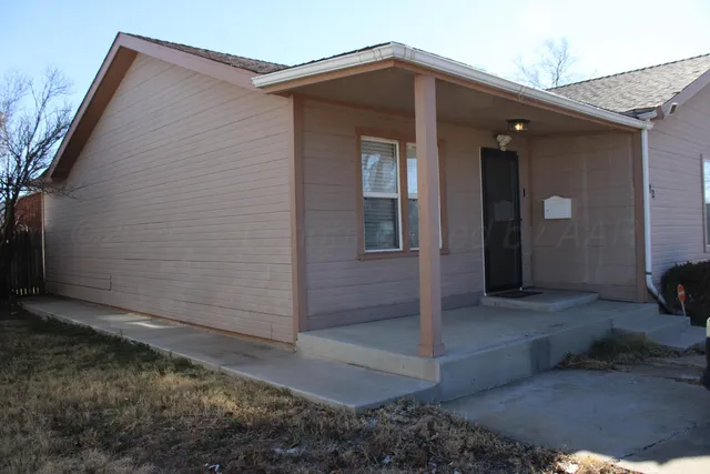 a view of a house with a small backyard
