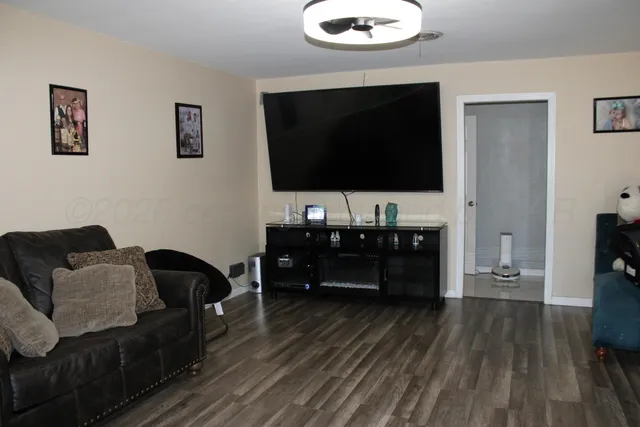 a living room with furniture and a flat screen tv