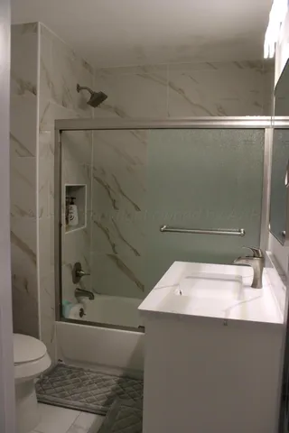 a kitchen with a refrigerator and a stove top oven