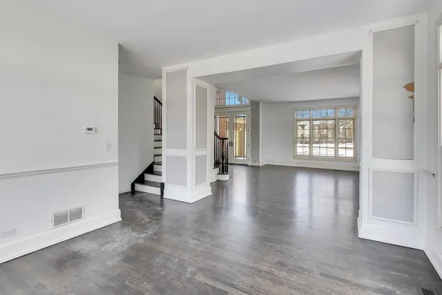 a living room with a fireplace and wooden floor