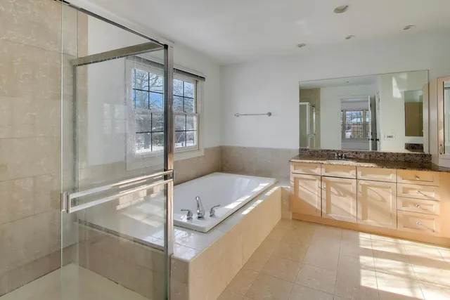 a bed room with a bed and a large window