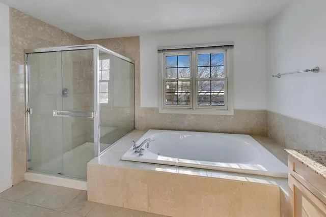 a living room with furniture a flat screen tv and a table