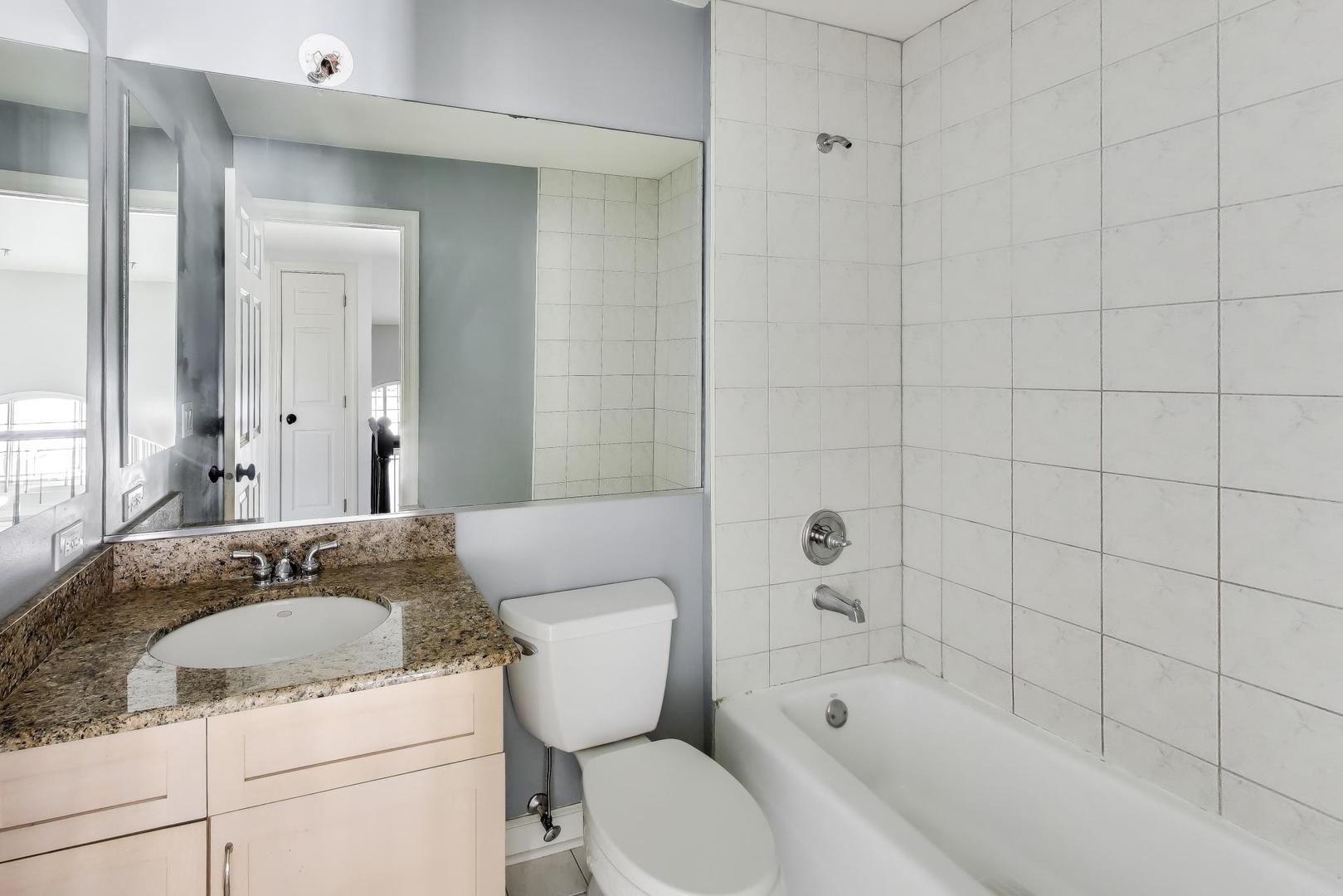 309 Ridge Road Highland Park, IL 60035 - Photo 51 of 71 a bathroom with a granite countertop toilet a sink and bathtub