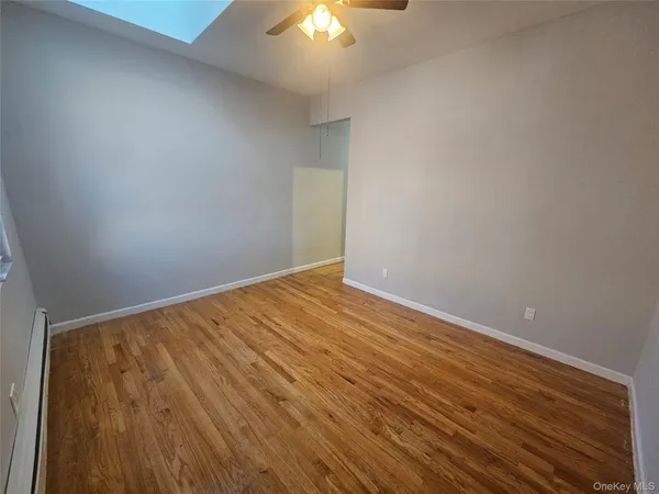 a view of a room with wooden floor
