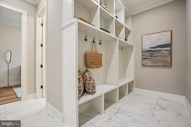 a spacious bedroom with a bed and a chandelier