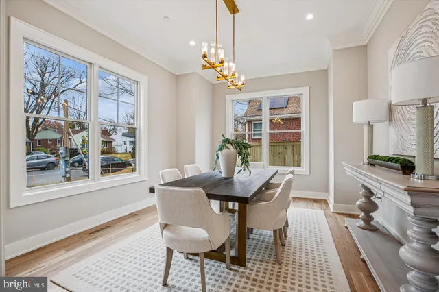 a view of a dining room with furniture a chandelier and wooden floor