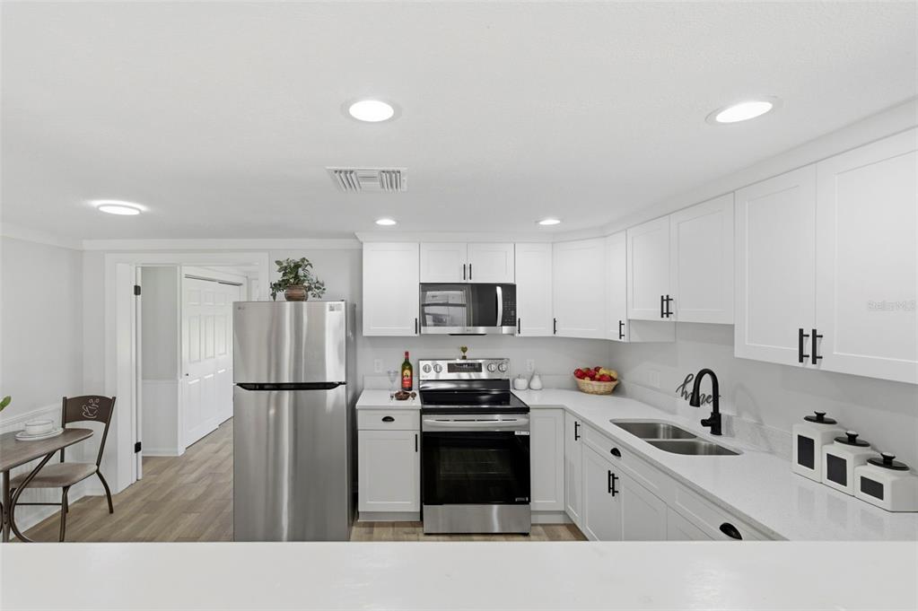 9033 Pegasus Avenue Port Richey, FL 34668 - Photo 9 of 56 a kitchen with a refrigerator and a sink