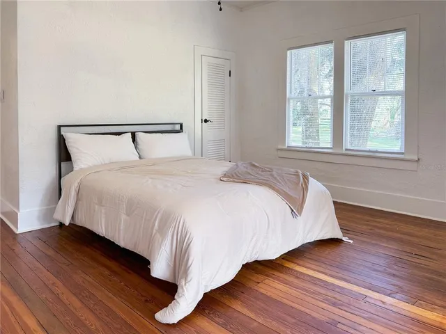 a view of a room with wooden floor and window