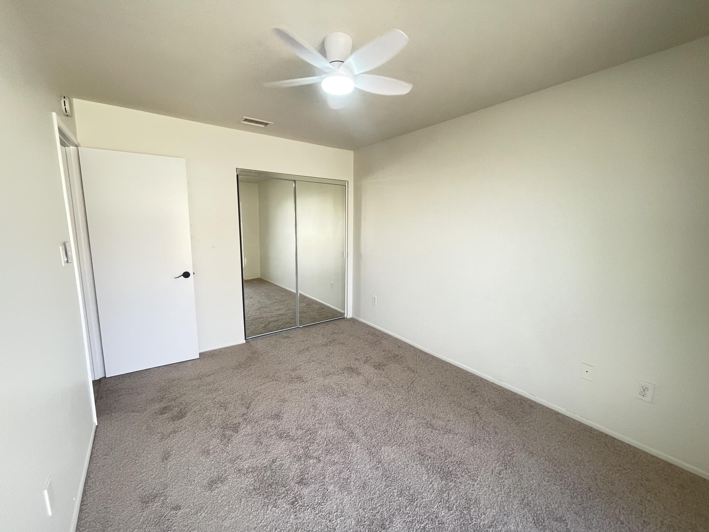 82567 Ave 48, Unit 36 Indio, CA 92201 - Photo 11 of 27 an empty room with a ceiling fan and a window