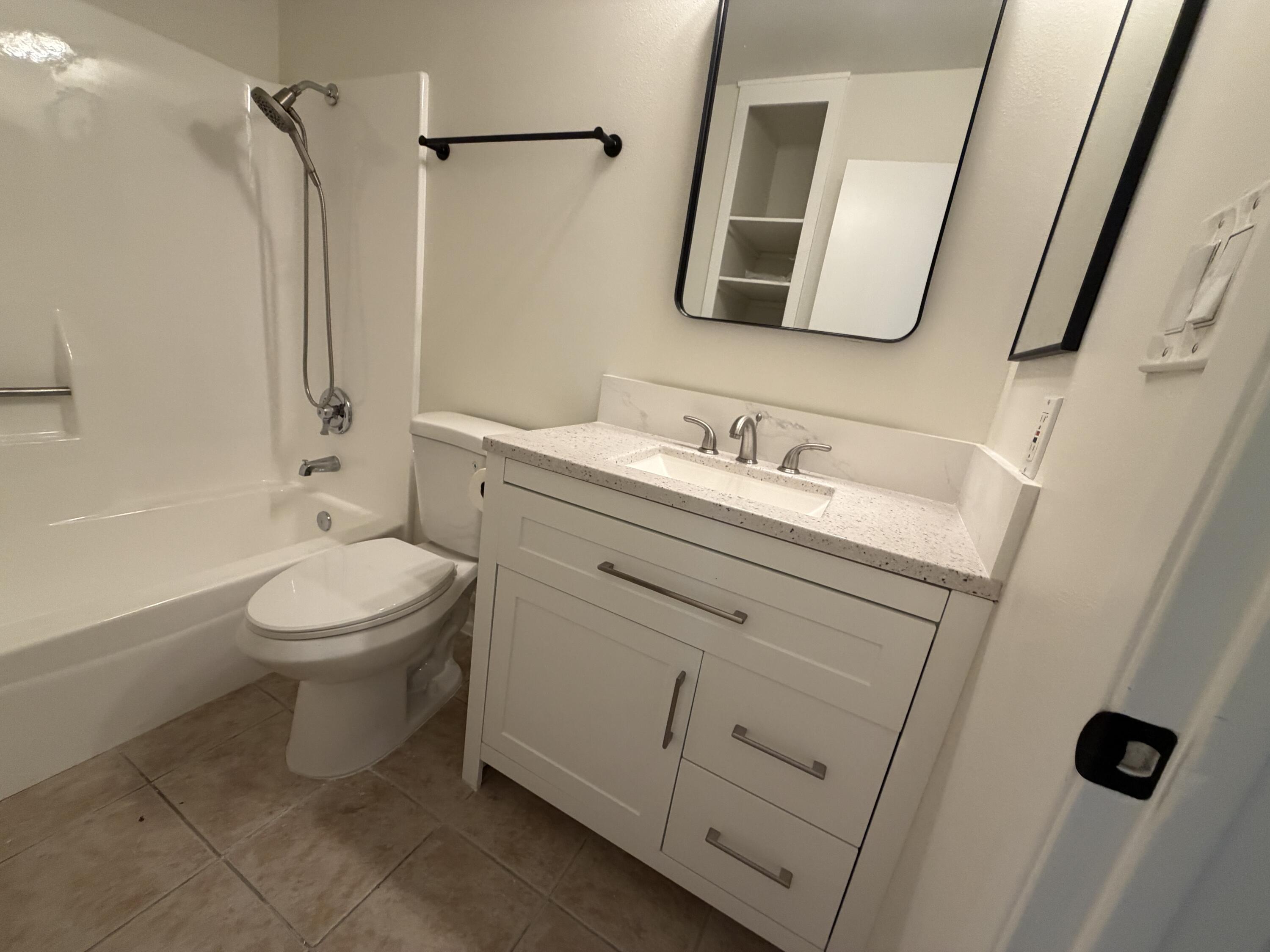 82567 Ave 48, Unit 36 Indio, CA 92201 - Photo 24 of 27 a bathroom with a toilet sink and mirror