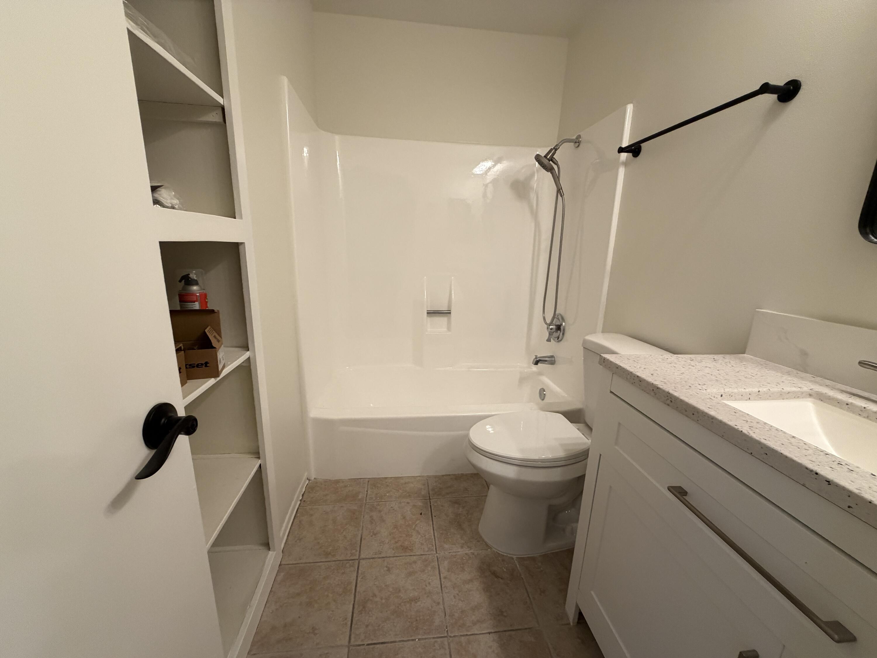 82567 Ave 48, Unit 36 Indio, CA 92201 - Photo 25 of 27 a bathroom with a granite countertop sink toilet and shower