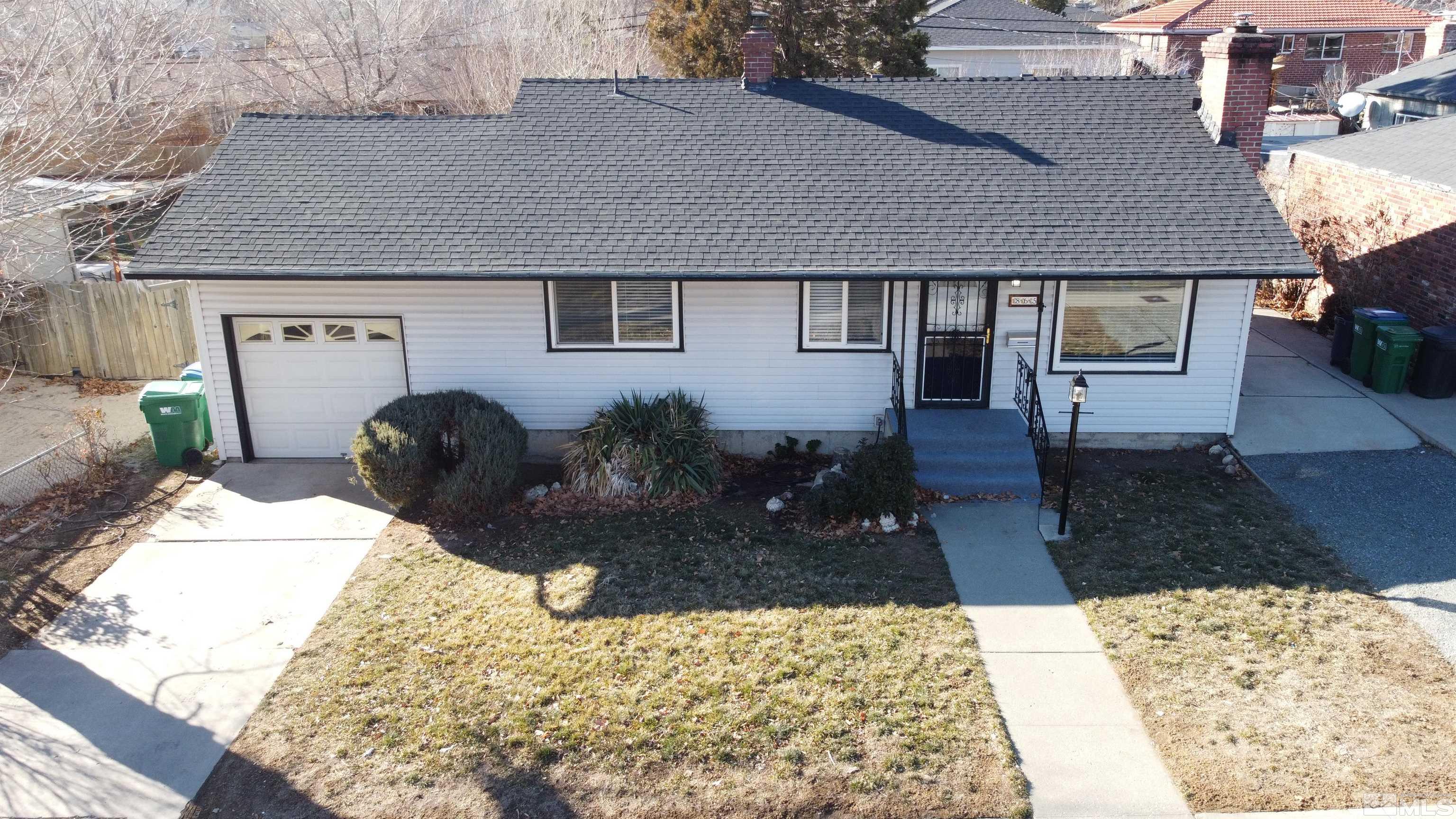 865 Wilkinson Avenue Reno, NV 89502 - Photo 1 of 36 a front view of a house with a yard