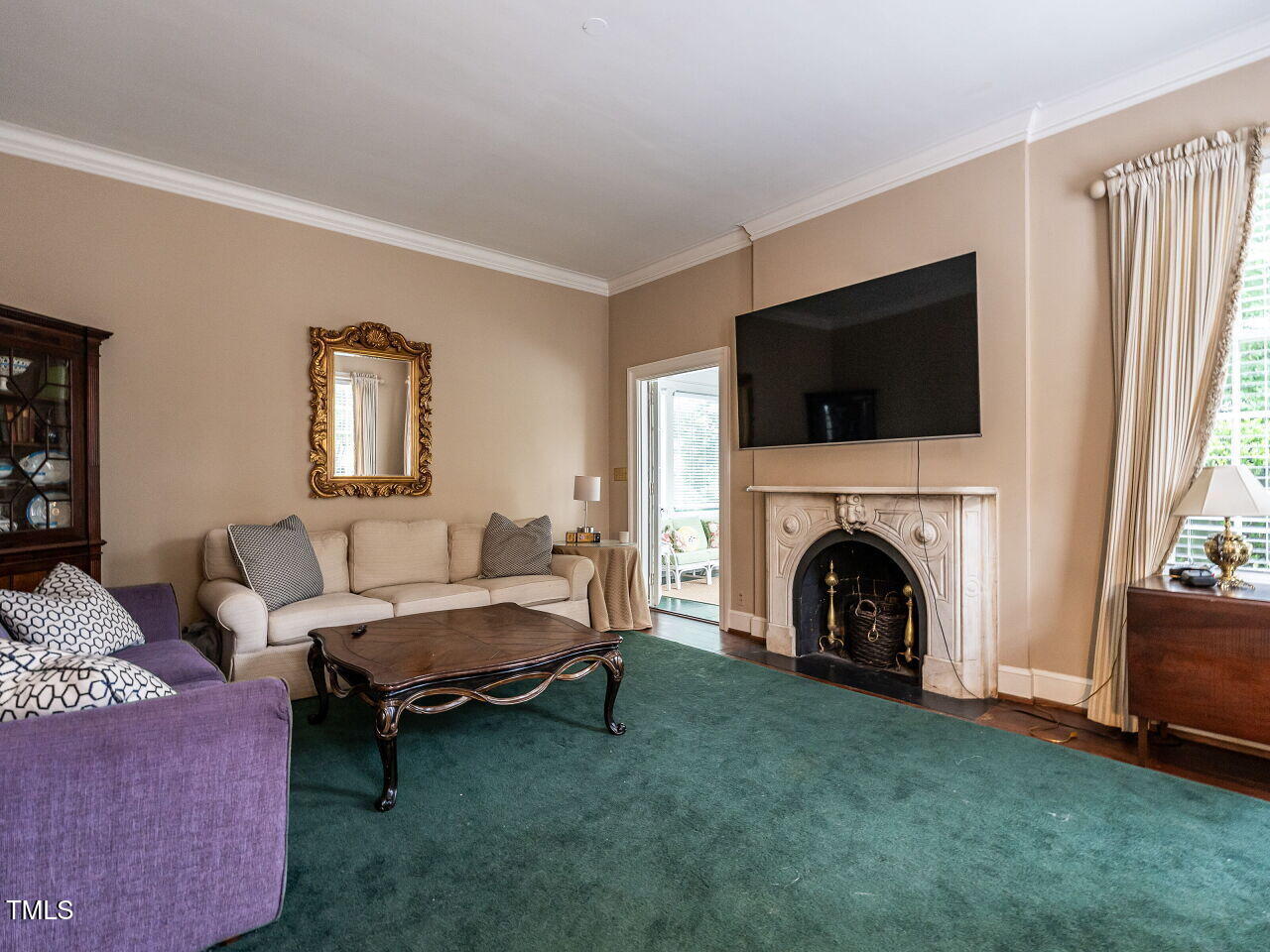 1930 Reid Street Raleigh, NC 27608 - Photo 5 of 31 a living room with furniture a flat screen tv and a fireplace