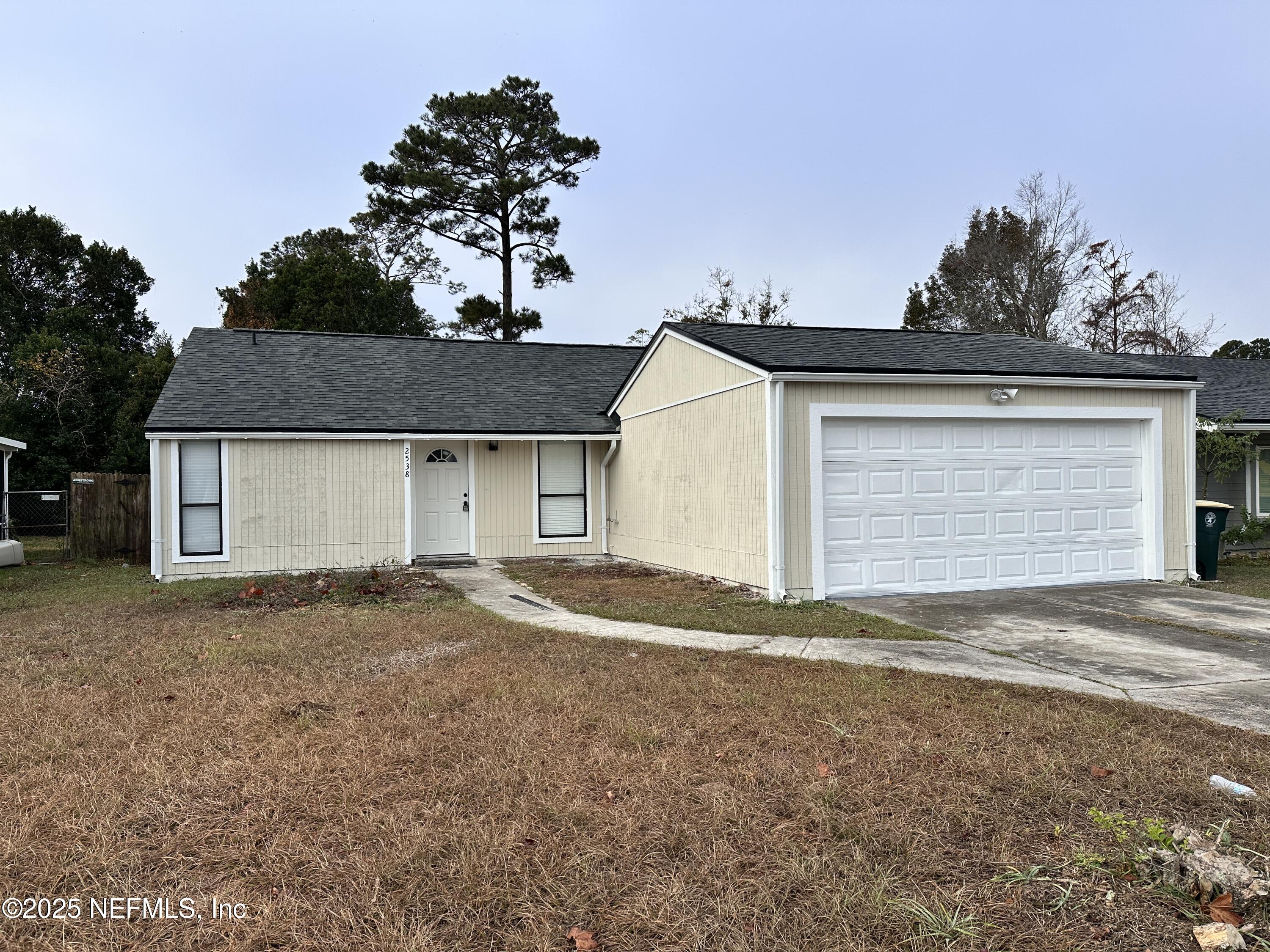 a front view of a house with a yard and garage