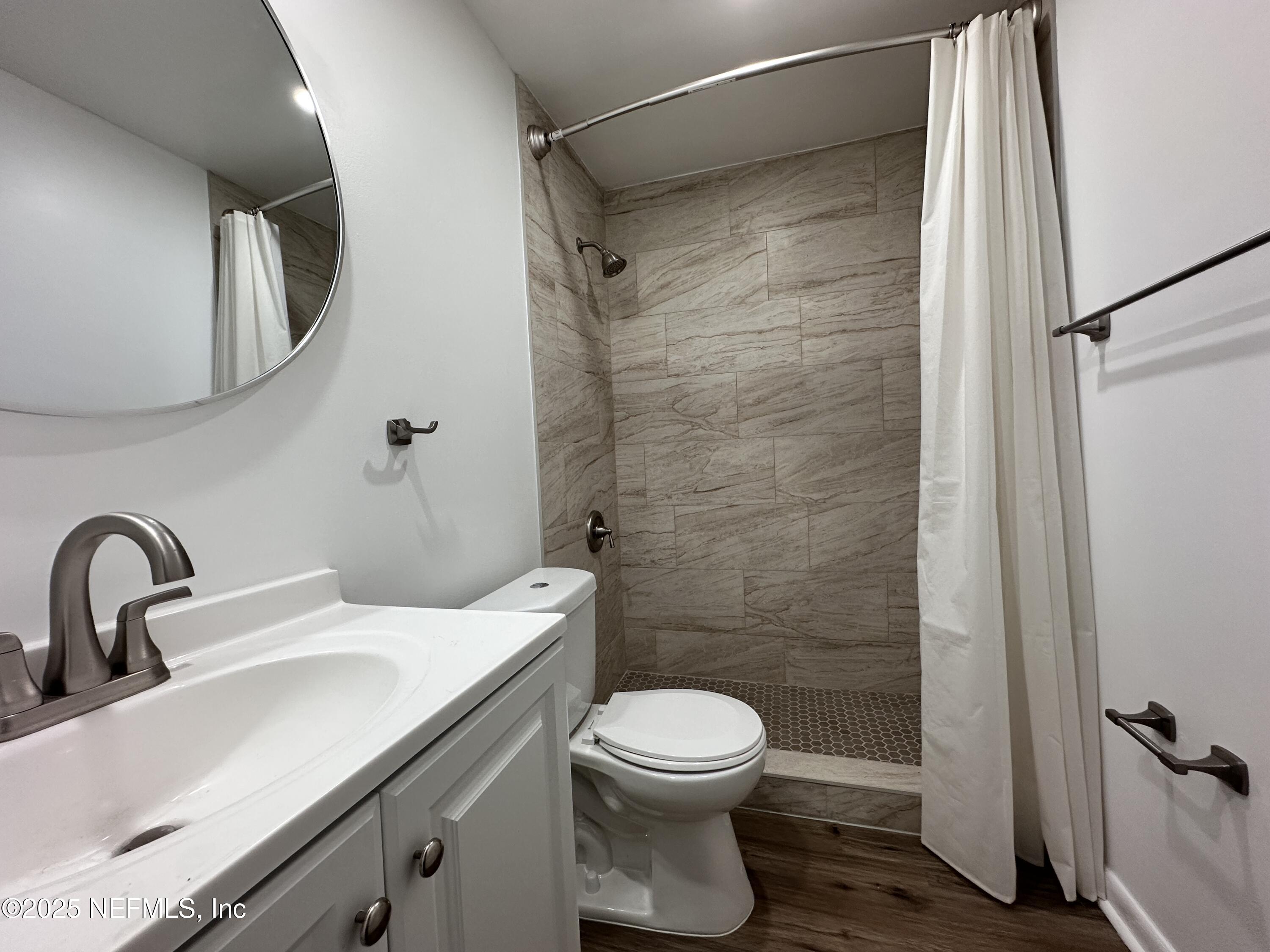 2538 Green Spring Drive Jacksonville, FL 32246 - Photo 11 of 15 a bathroom with a sink toilet and shower