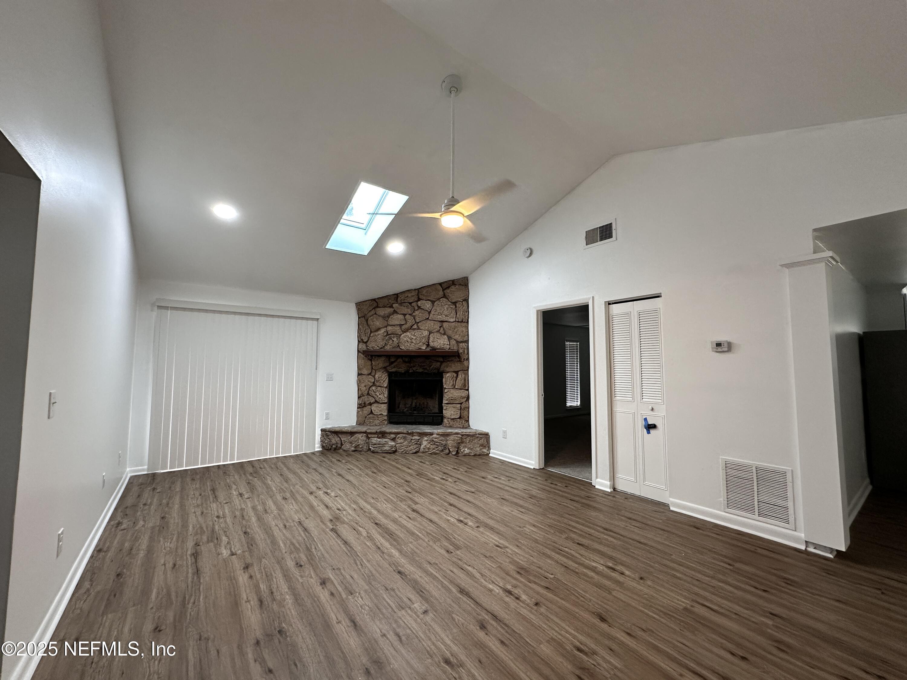 2538 Green Spring Drive Jacksonville, FL 32246 - Photo 2 of 15 an empty room with wooden floor and fireplace