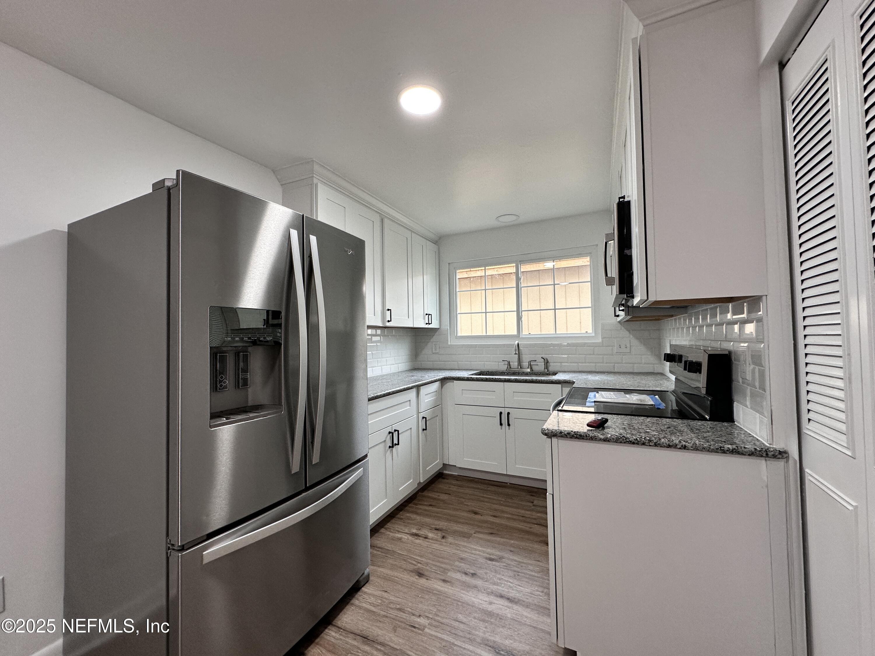 2538 Green Spring Drive Jacksonville, FL 32246 - Photo 6 of 15 a kitchen with granite countertop stainless steel appliances a refrigerator a sink a stove a microwave and cabinets