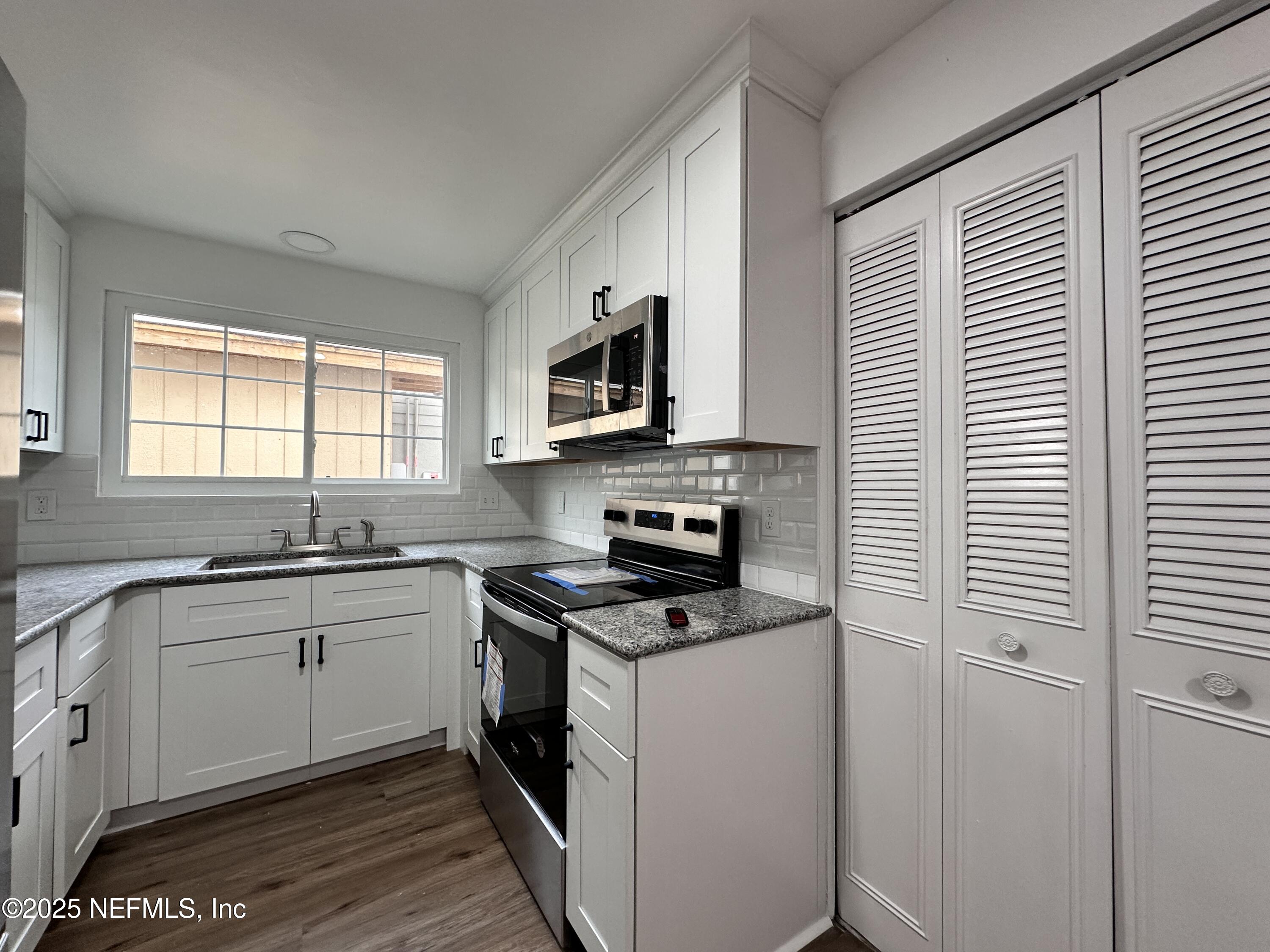 2538 Green Spring Drive Jacksonville, FL 32246 - Photo 7 of 15 a kitchen with a stove a sink and a window